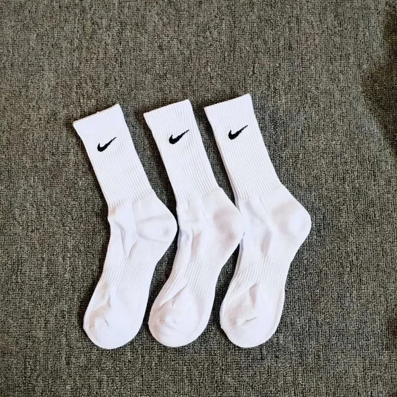 Three pairs of high-quality Nike long white socks.